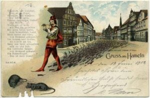 Auf der Grußkarte sieht man den Rattenfänger von Hameln, wie er die Ratten mit seiner Flöte aus der Stadt aus der Stadt lockt